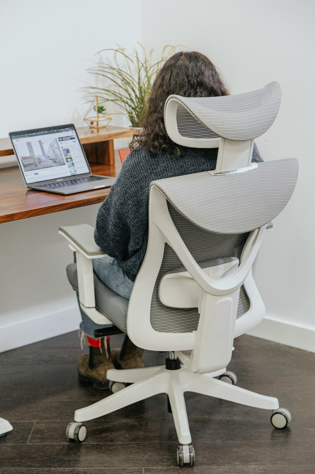 person stretching back at office desk