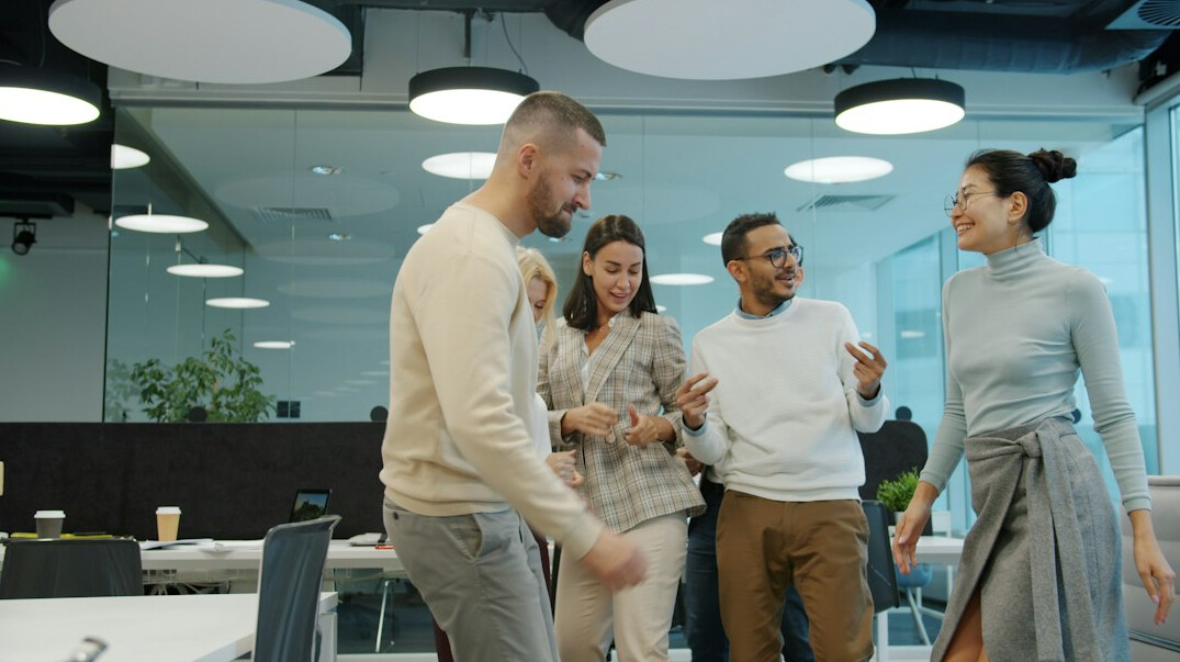 team stretching in office